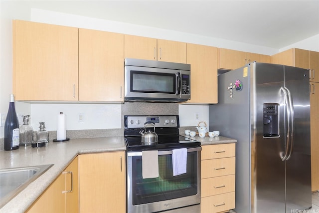 95-955 Ukuwai St Unit 1703, Mililani, HI 96789 - kitchen with stainless steel appliances, light brown cabinetry, light countertops, and a sink