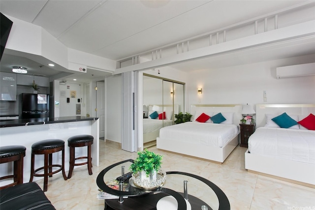 1777 Ala Moana Blvd Unit 937, Honolulu, HI 96815 - bedroom with an AC wall unit, light marble finish flooring, freestanding refrigerator, and a closet