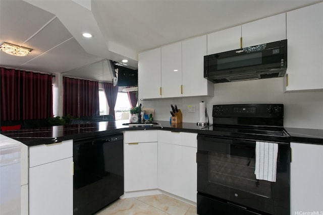 1777 Ala Moana Blvd Unit 937, Honolulu, HI 96815 - kitchen with black appliances, dark countertops, a peninsula, white cabinets, and light tile patterned floors