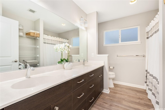 91-1160 Kamakana St Unit 609, Ewa Beach, HI 96706 - bathroom featuring baseboards, double vanity, toilet, and wood finished floors