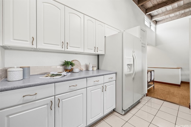 44-140-5MUIPL Mui Pl Unit 2705, Kaneohe, HI 96744 - kitchen featuring white fridge with ice dispenser, white cabinetry, light tile patterned floors, wood ceiling with exposed beams, and light countertops