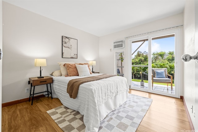 44-140-5MUIPL Mui Pl Unit 2705, Kaneohe, HI 96744 - bedroom featuring access to exterior, a wall mounted air conditioner, light wood-type flooring, and baseboards