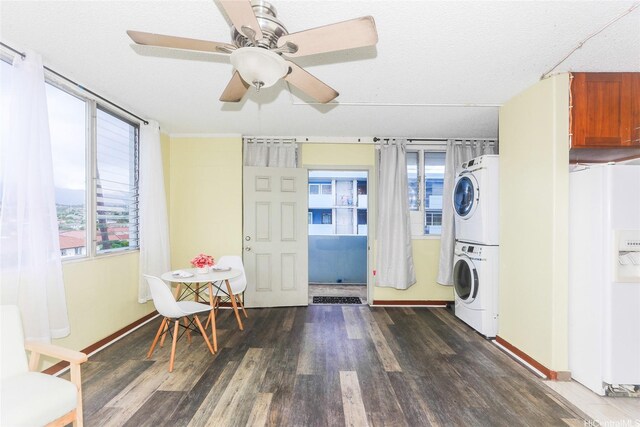 94-249 Waikele Rd Unit B209, Waipahu, HI 96797 - laundry room featuring stacked washer / drying machine, wood finished floors, ceiling fan, and baseboards
