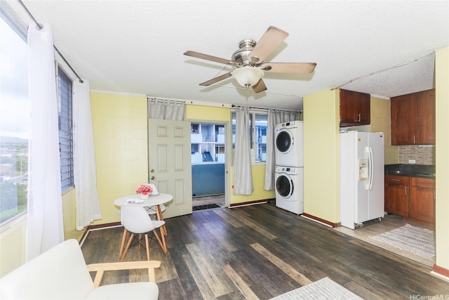 94-249 Waikele Rd Unit B209, Waipahu, HI 96797 - laundry area with stacked washer / drying machine, dark wood-style floors, a ceiling fan, and a textured ceiling