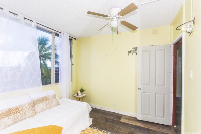 94-249 Waikele Rd Unit B209, Waipahu, HI 96797 - bedroom with wood finished floors, a textured ceiling, a ceiling fan, and baseboards
