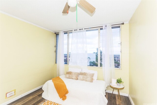 94-249 Waikele Rd Unit B209, Waipahu, HI 96797 - bedroom with baseboards, wood finished floors, crown molding, and a ceiling fan