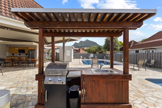 515 Keolu Dr Unit H, Kailua, HI 96734 - fenced backyard with a mountain view, a patio, a grill, and outdoor dining space