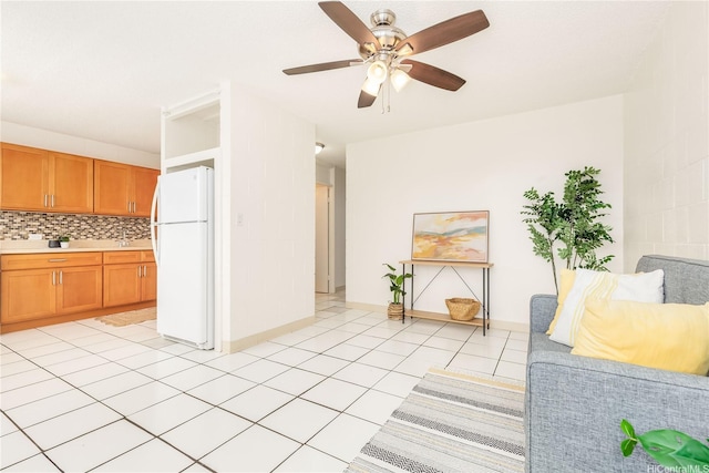 1519 Kaumualii St Unit 316, Honolulu, HI 96817 - living area with light tile patterned floors, a ceiling fan, and baseboards
