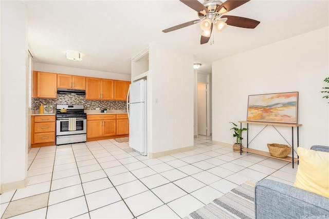 1519 Kaumualii St Unit 316, Honolulu, HI 96817 - kitchen with stainless steel gas stove, freestanding refrigerator, under cabinet range hood, open floor plan, and light countertops