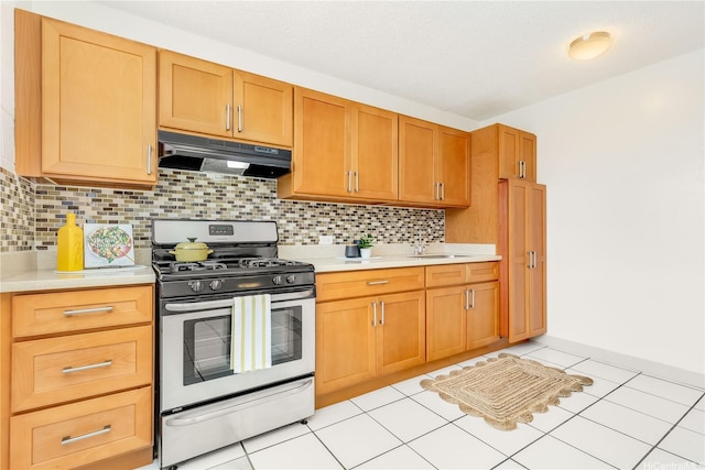 1519 Kaumualii St Unit 316, Honolulu, HI 96817 - kitchen featuring stainless steel gas range, under cabinet range hood, light countertops, and a sink