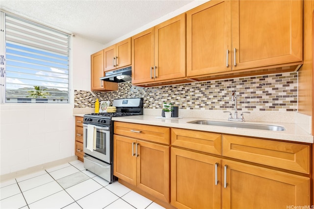 1519 Kaumualii St Unit 316, Honolulu, HI 96817 - kitchen featuring gas stove, a sink, light countertops, under cabinet range hood, and light tile patterned floors