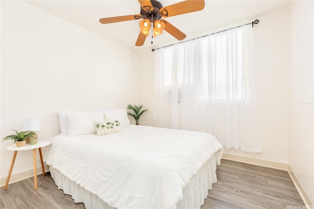 1519 Kaumualii St Unit 316, Honolulu, HI 96817 - bedroom with light wood-type flooring, ceiling fan, and baseboards