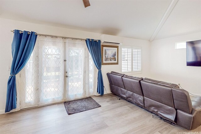 91-215 Keonekapu Pl, Ewa Beach, HI 96706 - living room with an AC wall unit, wood finished floors, and baseboards