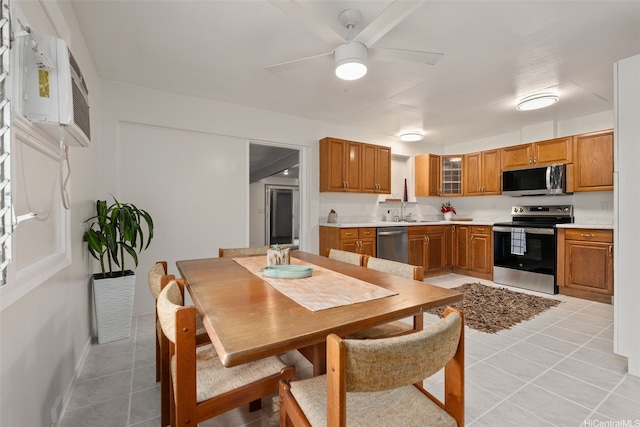 41-179 Nalu St, Waimanalo, HI 96795 - kitchen with appliances with stainless steel finishes, light tile patterned floors, brown cabinetry, light countertops, and ceiling fan