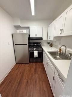 87-130 Helelua St Unit E102, Waianae, HI 96792 - kitchen with stainless steel appliances, white cabinets, dark wood-style flooring, and light countertops