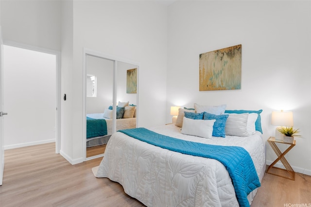 174 Hauoli St, Kailua, HI 96734 - bedroom featuring wood finished floors, a towering ceiling, a closet, and baseboards