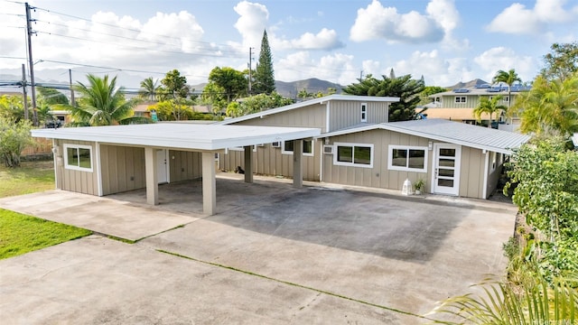 174 Hauoli St, Kailua, HI 96734 - view of front facade featuring concrete driveway and board and batten siding