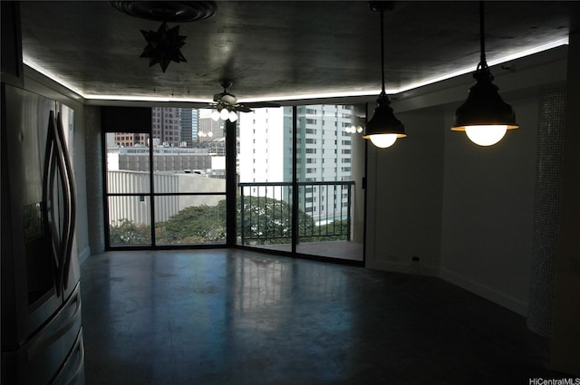 60 N Beretania St Unit 909, Honolulu, HI 96817 - unfurnished dining area featuring healthy amount of natural light, a wall of windows, concrete flooring, baseboards, and ceiling fan