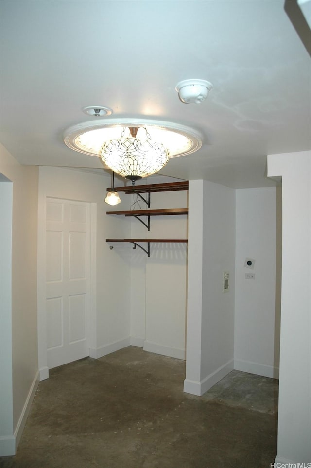 60 N Beretania St Unit 909, Honolulu, HI 96817 - hallway with concrete flooring, baseboards, and a chandelier