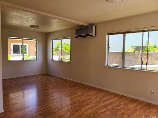 2317 Lime St Unit 2317, Honolulu, HI 96826 - empty room with a wall mounted air conditioner, wood finished floors, and baseboards
