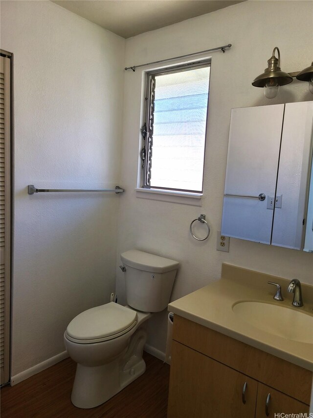 2317 Lime St Unit 2317, Honolulu, HI 96826 - bathroom with baseboards, vanity, toilet, and wood finished floors