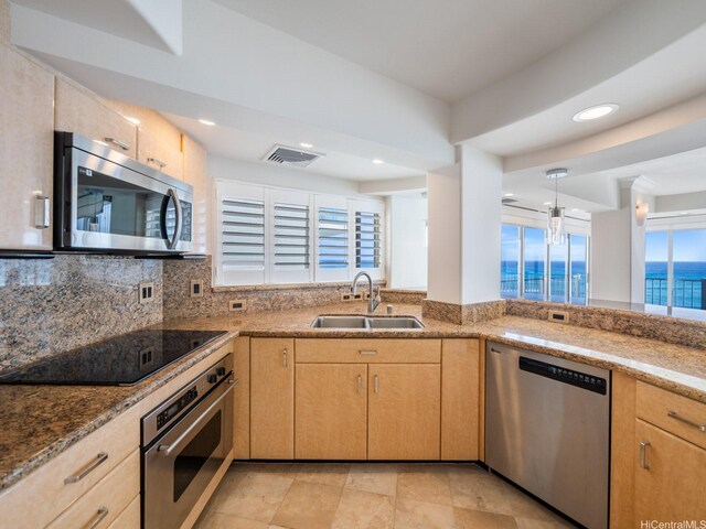 3015 Kalakaua Ave Unit 901, Honolulu, HI 96815 - kitchen featuring stainless steel appliances, a sink, light brown cabinets, light stone countertops, and tasteful backsplash