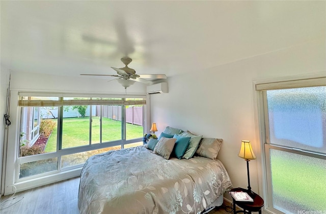 225 Aikane St, Kailua, HI 96734 - bedroom with a wall mounted air conditioner, wood finished floors, and a ceiling fan