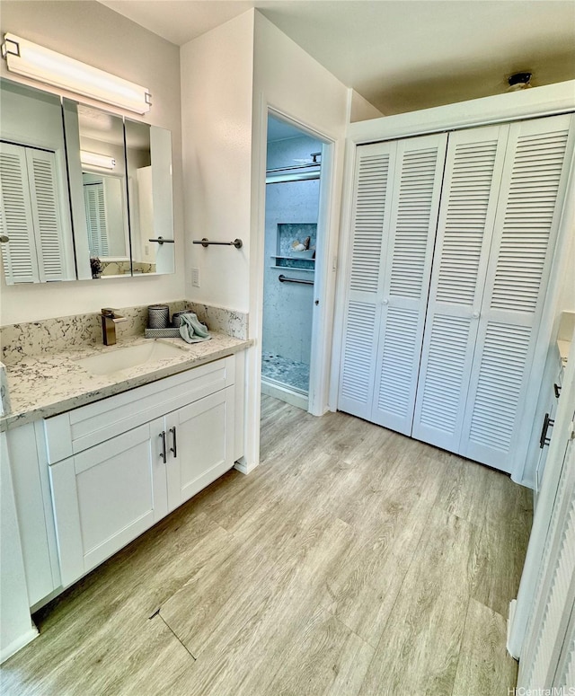 225 Aikane St, Kailua, HI 96734 - full bathroom featuring a closet, vanity, wood finished floors, and a stall shower