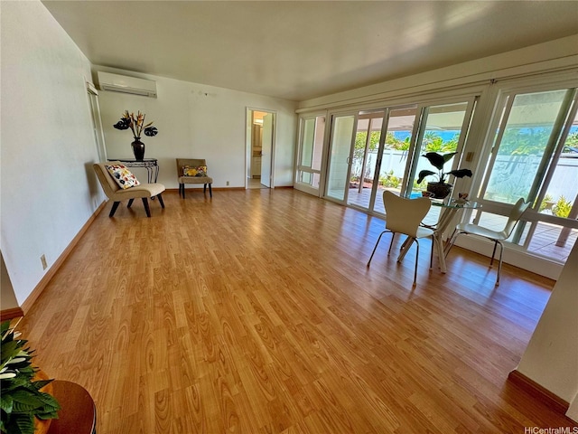 225 Aikane St, Kailua, HI 96734 - living area featuring an AC wall unit and light wood-style flooring