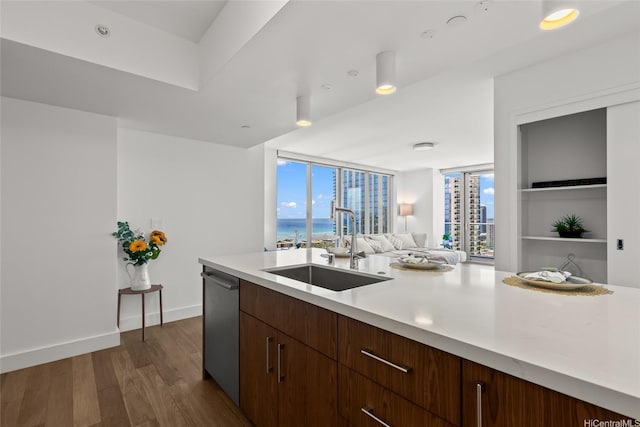 629 Keeaumoku St Unit 2912, Honolulu, HI 96814 - kitchen with a sink, stainless steel dishwasher, light countertops, dark wood finished floors, and plenty of natural light