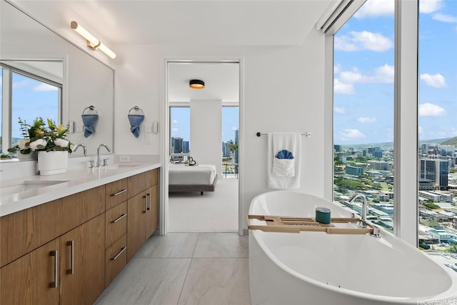 629 Keeaumoku St Unit 2912, Honolulu, HI 96814 - bathroom featuring a soaking tub, double vanity, plenty of natural light, and a view of city