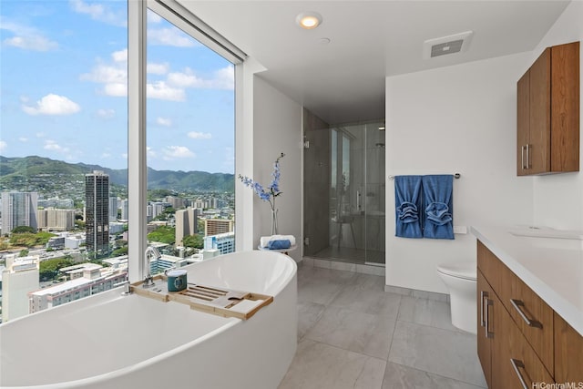 629 Keeaumoku St Unit 2912, Honolulu, HI 96814 - bathroom featuring a mountain view, a soaking tub, a shower stall, vanity, and a view of city