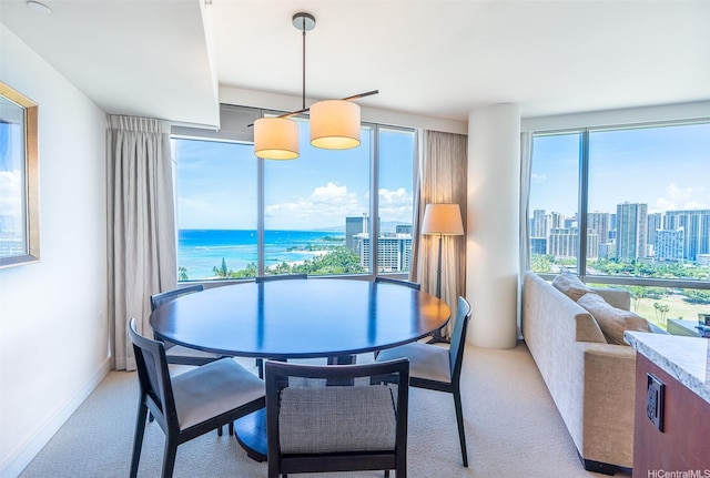 223 Saratoga Rd Unit 2203, Honolulu, HI 96815 - dining room with light carpet, a city view, and baseboards