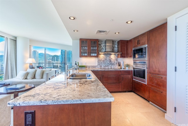 223 Saratoga Rd Unit 2203, Honolulu, HI 96815 - kitchen featuring black appliances, wall chimney exhaust hood, a peninsula, plenty of natural light, and recessed lighting