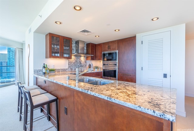 223 Saratoga Rd Unit 2203, Honolulu, HI 96815 - kitchen with stainless steel oven, built in microwave, wall chimney range hood, recessed lighting, and light stone countertops
