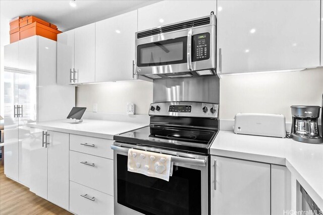 888 Kapiolani Blvd Unit 1512, Honolulu, HI 96813 - kitchen featuring stainless steel appliances, white cabinetry, and light countertops