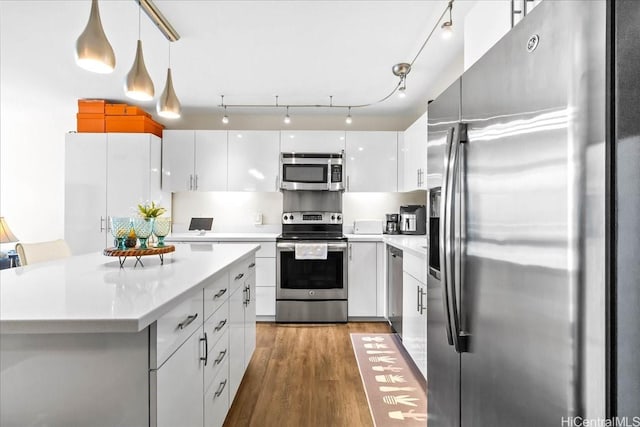 888 Kapiolani Blvd Unit 1512, Honolulu, HI 96813 - kitchen with stainless steel appliances, white cabinetry, wood finished floors, and light countertops