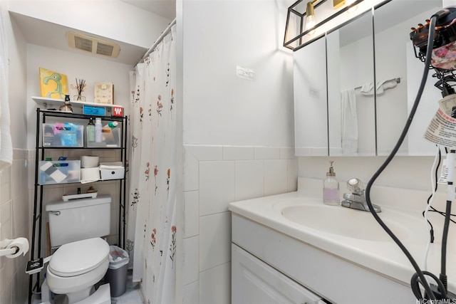 2421 Tusitala St Unit 803, Honolulu, HI 96815 - bathroom featuring tile walls, toilet, and vanity