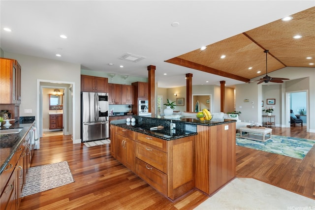 44-97 Kalenakai Pl Unit A, Kaneohe, HI 96744 - kitchen with stainless steel fridge, light wood-type flooring, decorative columns, a center island, and recessed lighting
