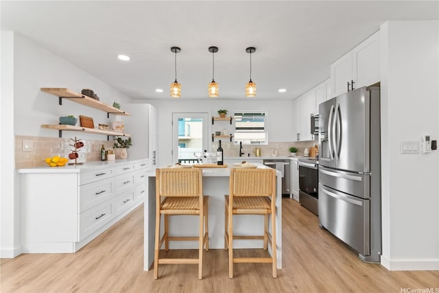 631 Punaa St, Kailua, HI 96734 - kitchen with stainless steel appliances, open shelves, light wood-type flooring, light countertops, and recessed lighting