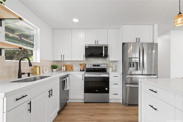 631 Punaa St, Kailua, HI 96734 - kitchen with appliances with stainless steel finishes, a sink, light countertops, backsplash, and recessed lighting