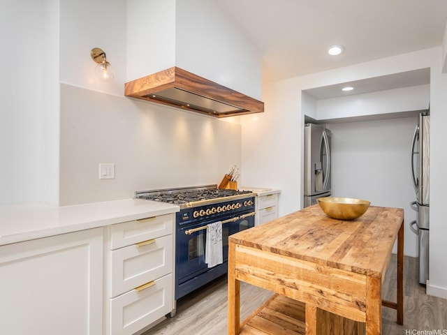 67-342 Kukea Cir, Waialua, HI 96791 - kitchen featuring range with gas stovetop, stainless steel fridge with ice dispenser, custom range hood, white cabinets, and light wood-type flooring