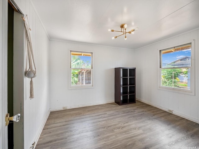 67-342 Kukea Cir, Waialua, HI 96791 - empty room featuring a chandelier, crown molding, plenty of natural light, wood finished floors, and baseboards