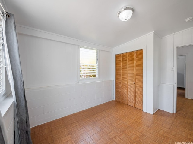 67-342 Kukea Cir, Waialua, HI 96791 - unfurnished bedroom featuring a closet, ornamental molding, and concrete block wall