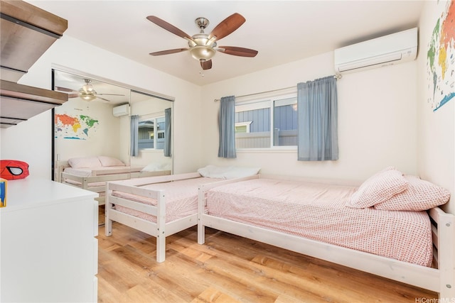 84-575 Kili Dr Unit 53, Waianae, HI 96792 - bedroom with a wall unit AC, light wood-style floors, and ceiling fan