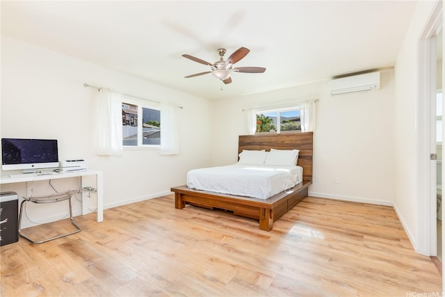 84-575 Kili Dr Unit 53, Waianae, HI 96792 - bedroom featuring a wall mounted air conditioner, wood finished floors, baseboards, and ceiling fan