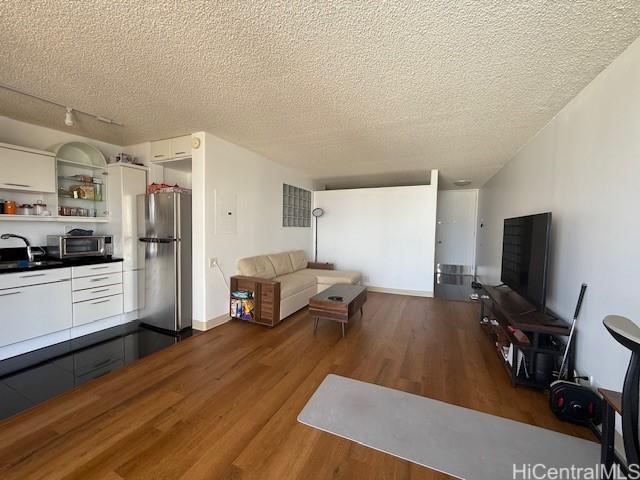 1630 Liholiho St Unit 2001, Honolulu, HI 96822 - living area with wood finished floors and a textured ceiling