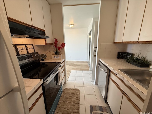 400 Hobron Ln Unit 2114, Honolulu, HI 96815 - kitchen featuring tile counters, electric range, under cabinet range hood, dishwasher, and tasteful backsplash