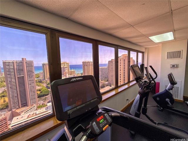 400 Hobron Ln Unit 2114, Honolulu, HI 96815 - exercise room featuring a paneled ceiling, a view of city, plenty of natural light, and a water view