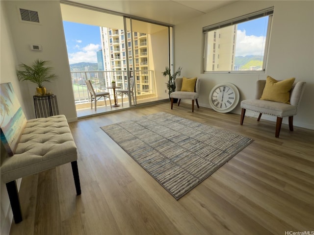 400 Hobron Ln Unit 2114, Honolulu, HI 96815 - living area featuring healthy amount of natural light, wood finished floors, and a city view